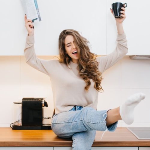 graceful-caucasian-girl-wears-jeans-enjoying-good-morning-her-kitchen (1)